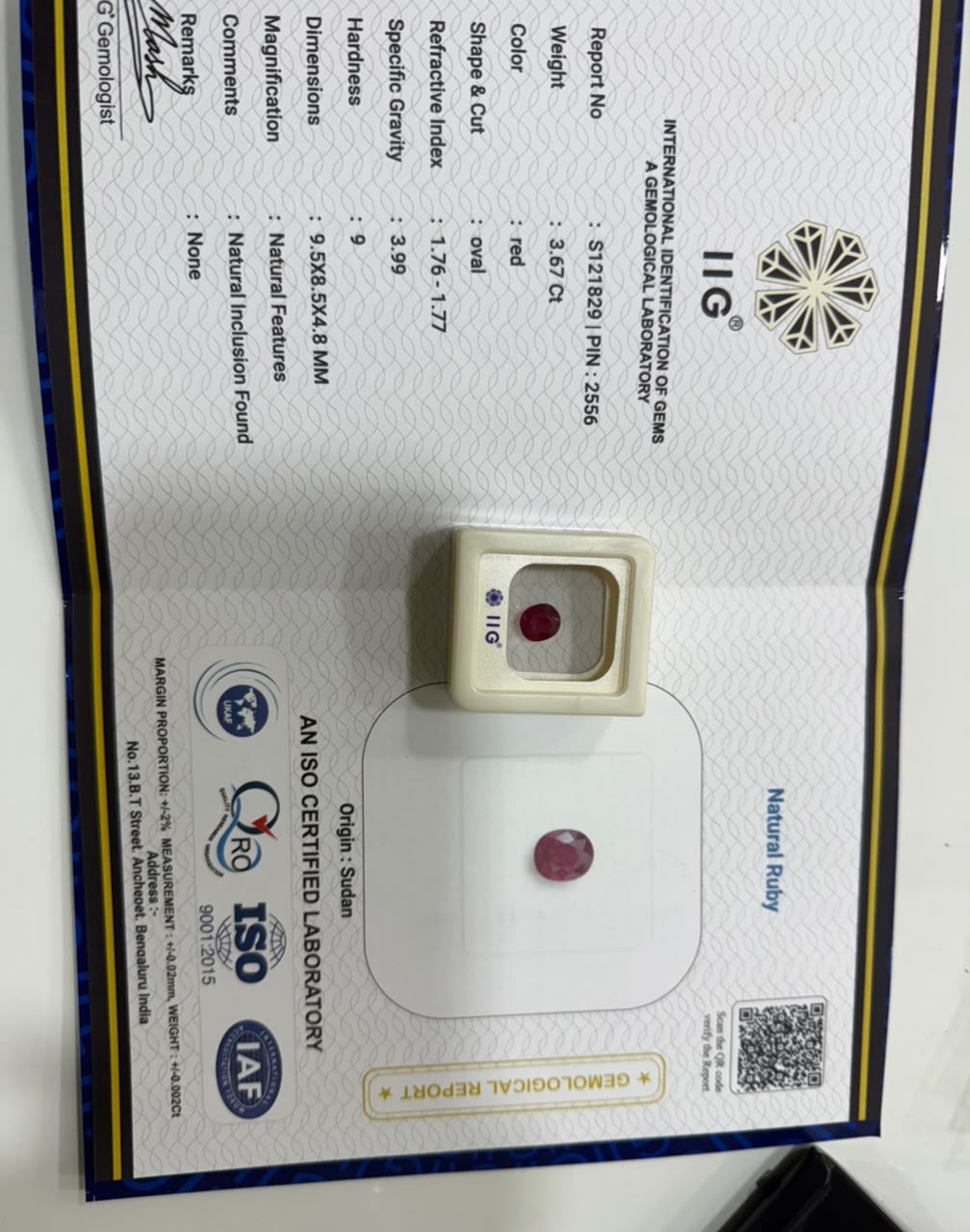 A gemstone identification and certification report from the International Institute of Gemmology and Silverware (IIG) and AIAB, featuring a small round red gemstone and its certificate details.

All details of the stone mentioned in this IIG certificate. 