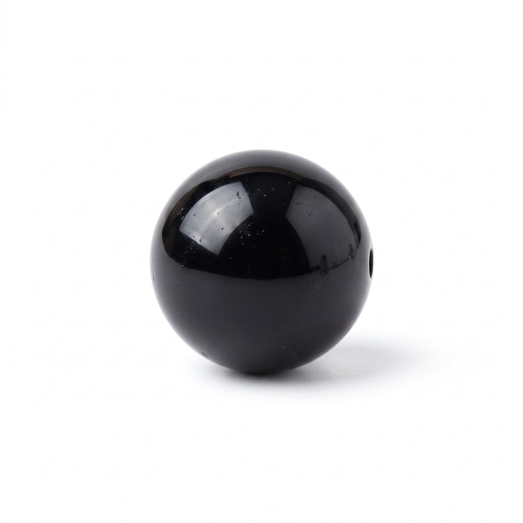 Polished natural black obsidian gemstone bead on white background for DIY energy protection bracelets by Bright Blue Gemstones India